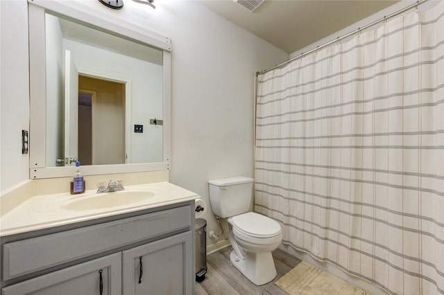 2910 Yearling Colt Ct, Houston, TX 77038 - bathroom with toilet, vanity, wood finished floors, and a shower with shower curtain