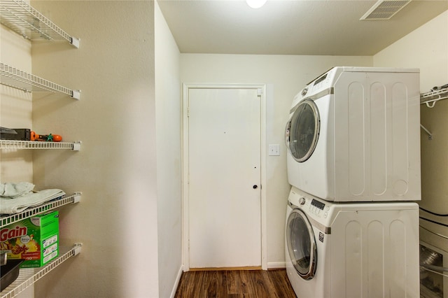 2910 Yearling Colt Ct, Houston, TX 77038 - laundry area with estacked washer and dryer, dark wood-style flooring, and baseboards