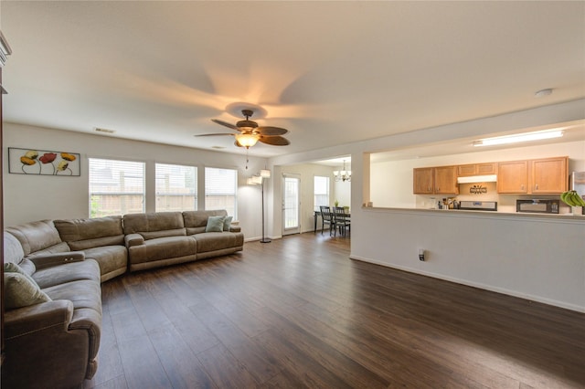 2910 Yearling Colt Ct, Houston, TX 77038 - living area with ceiling fan, dark wood-style flooring, a chandelier, and baseboards