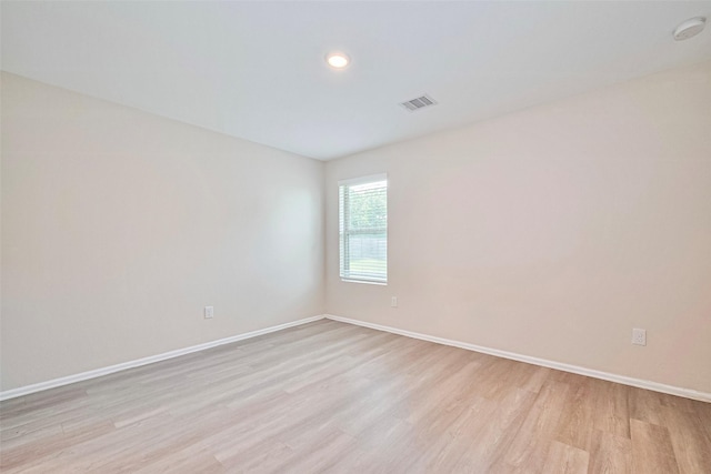 14627 Woodcott Warren Way, Pearland, TX 77545 - unfurnished room with light wood-type flooring, a smoke detector, and baseboards