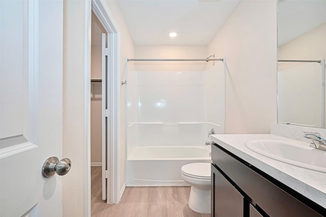14627 Woodcott Warren Way, Pearland, TX 77545 - bathroom featuring vanity, wood finished floors, toilet, tub / shower combination, and a walk in closet