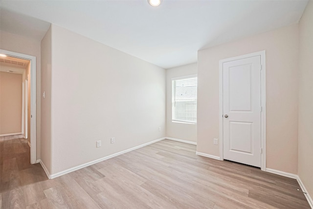 14627 Woodcott Warren Way, Pearland, TX 77545 - unfurnished bedroom with light wood finished floors and baseboards