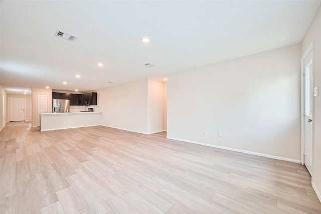 14627 Woodcott Warren Way, Pearland, TX 77545 - unfurnished living room with light wood-type flooring, baseboards, and recessed lighting