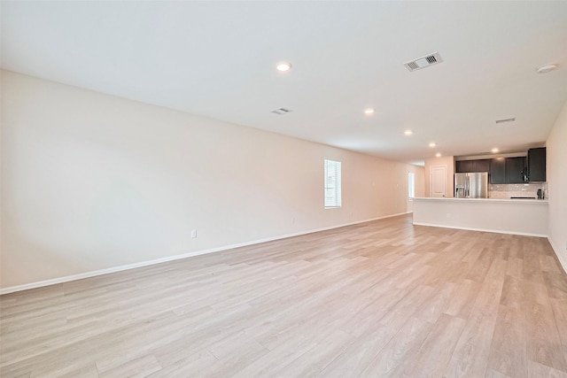 14627 Woodcott Warren Way, Pearland, TX 77545 - unfurnished living room with light wood finished floors, recessed lighting, and baseboards