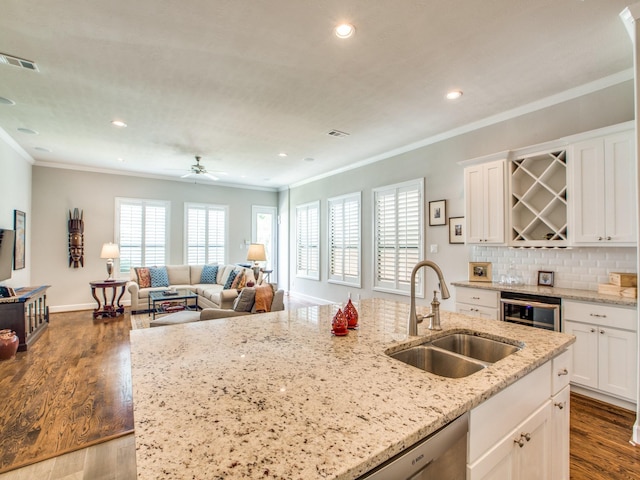 221 W 25th St Unit A, Houston, TX 77008 - kitchen with a sink, ornamental molding, white cabinets, recessed lighting, and dark wood finished floors