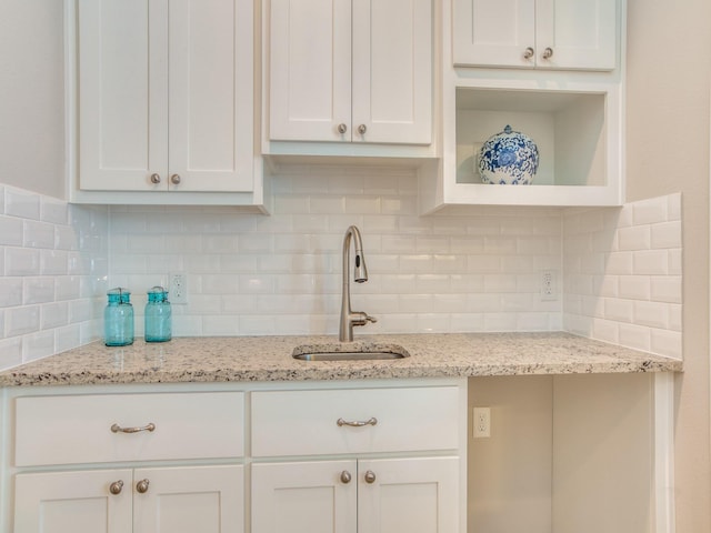 221 W 25th St Unit A, Houston, TX 77008 - kitchen with a sink, white cabinetry, tasteful backsplash, and light stone countertops
