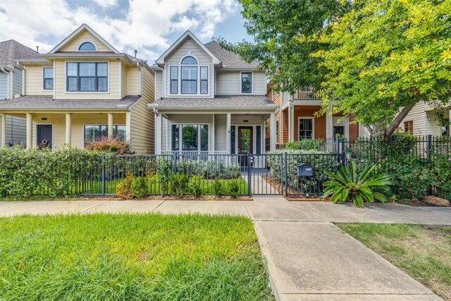 221 W 25th St Unit A, Houston, TX 77008 - view of front of home with covered porch, a fenced front yard, roof with shingles, and a gate