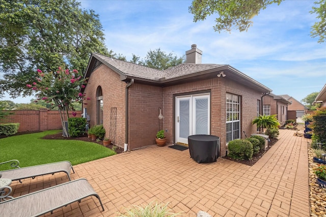1902 Carriage Brook Way, Houston, TX 77062 - rear view of house featuring brick siding, a patio, a chimney, and a shingled roof