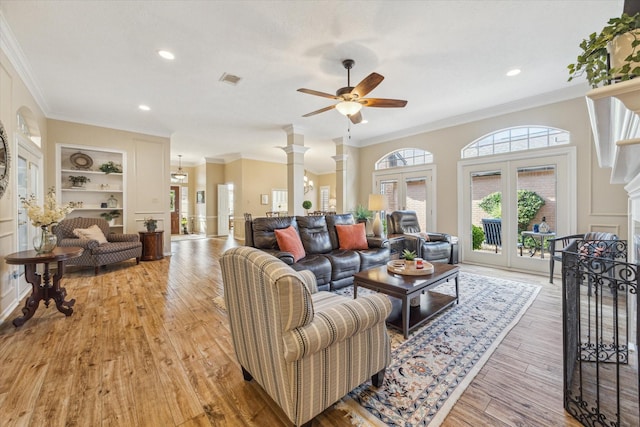 1902 Carriage Brook Way, Houston, TX 77062 - living area with a ceiling fan, crown molding, built in features, light wood-style floors, and decorative columns