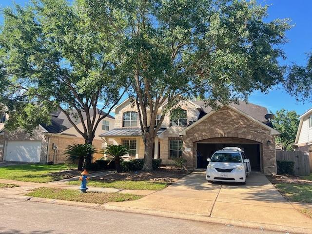 11608 Summer Moon Dr, Pearland, TX 77584 - traditional-style house with concrete driveway and an attached garage