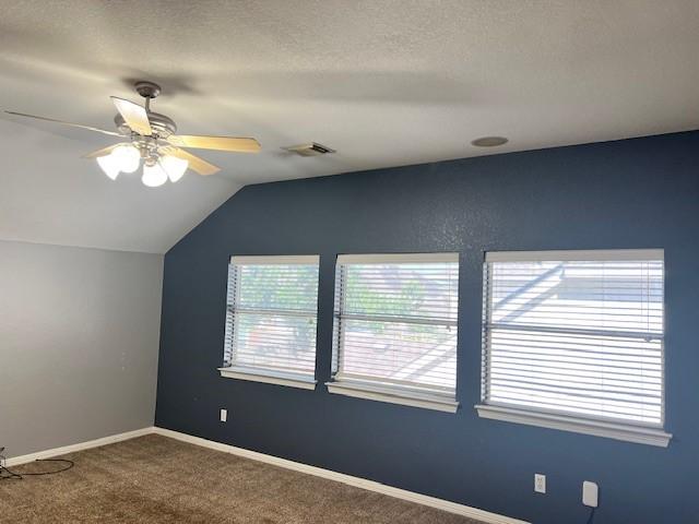 11608 Summer Moon Dr, Pearland, TX 77584 - empty room featuring vaulted ceiling, carpet flooring, a ceiling fan, and baseboards