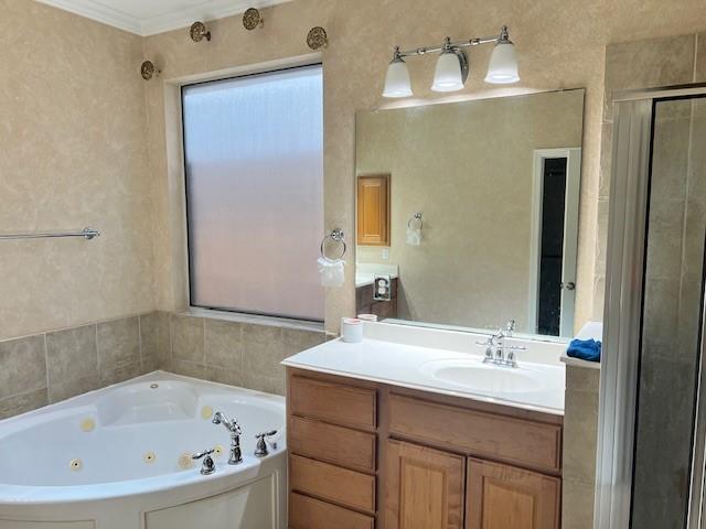 11608 Summer Moon Dr, Pearland, TX 77584 - bathroom with vanity, a jetted tub, a shower stall, and crown molding