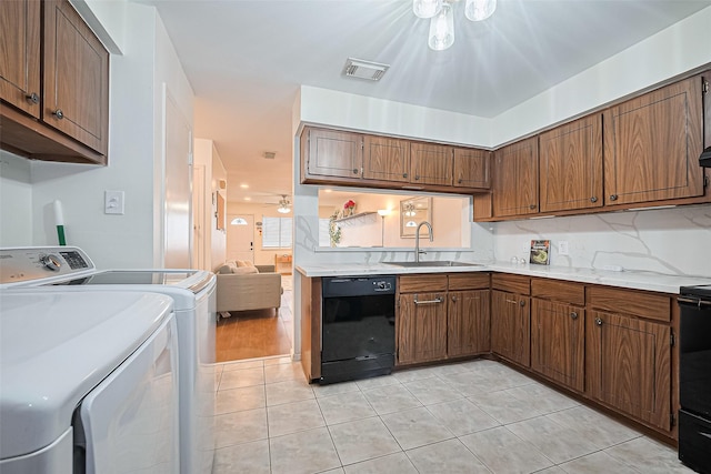 4304 Sherwood Ln Unit 106, Houston, TX 77092 - kitchen with black dishwasher, a sink, independent washer and dryer, light tile patterned flooring, and light countertops