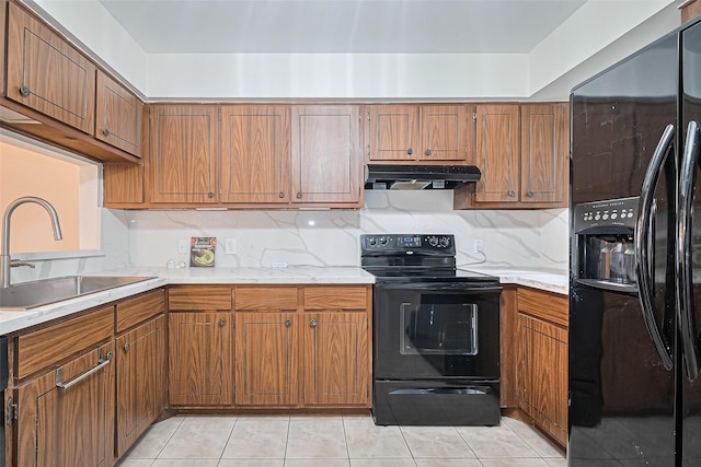 4304 Sherwood Ln Unit 106, Houston, TX 77092 - kitchen with black appliances, under cabinet range hood, a sink, and brown cabinets