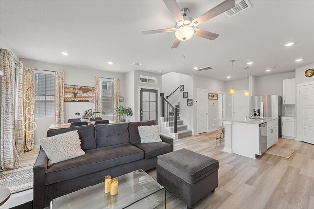 3125 Skyrock Dr, Houston, TX 77063 - living area featuring ceiling fan, light wood-style flooring, stairs, and recessed lighting