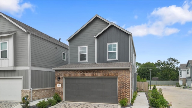 3125 Skyrock Dr, Houston, TX 77063 - view of front of house with brick siding, board and batten siding, driveway, and an attached garage