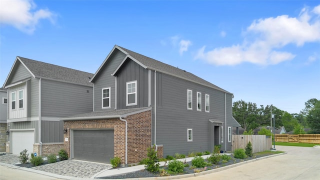3125 Skyrock Dr, Houston, TX 77063 - view of side of home with board and batten siding, an attached garage, brick siding, and driveway