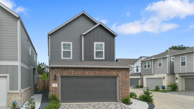 3125 Skyrock Dr, Houston, TX 77063 - view of front facade with brick siding, board and batten siding, a garage, and driveway