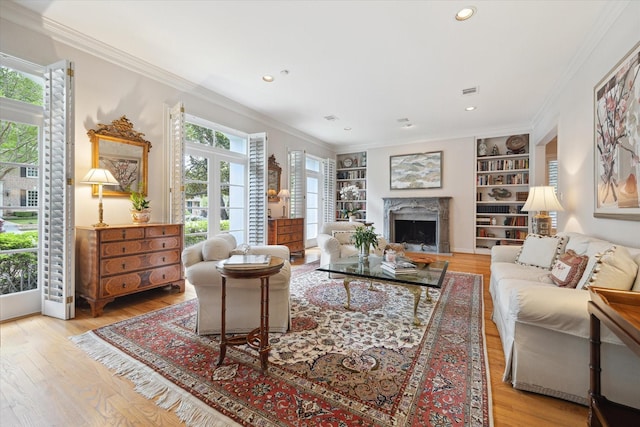 3633 Overbrook Ln, Houston, TX 77027 - living area with wood finished floors, a premium fireplace, built in features, crown molding, and recessed lighting