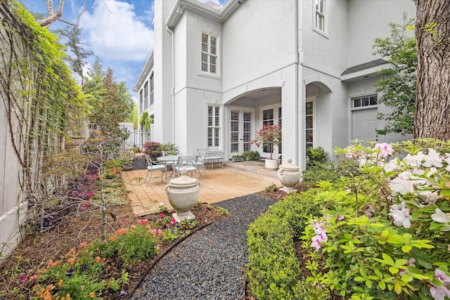 3633 Overbrook Ln, Houston, TX 77027 - back of house with stucco siding and a patio area