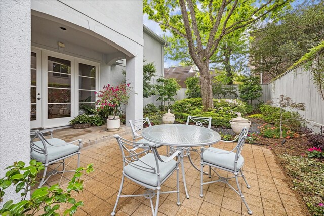 3633 Overbrook Ln, Houston, TX 77027 - fenced backyard with a patio, outdoor dining space, and french doors