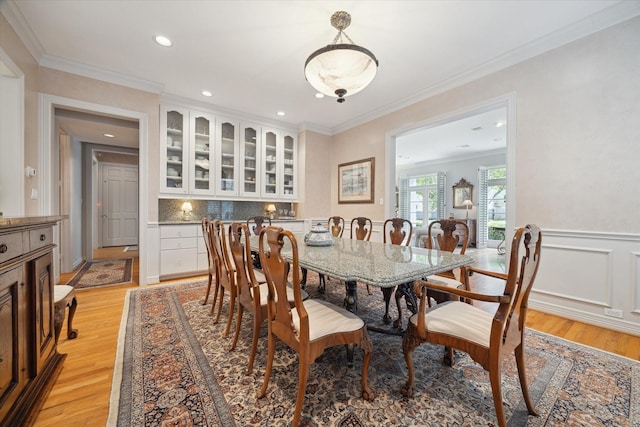 3633 Overbrook Ln, Houston, TX 77027 - dining space with light wood-type flooring, recessed lighting, crown molding, and wainscoting