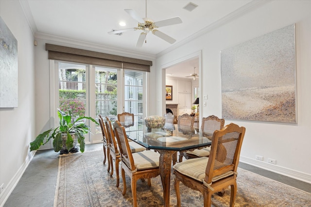 3633 Overbrook Ln, Houston, TX 77027 - dining area with crown molding, a ceiling fan, baseboards, and a fireplace