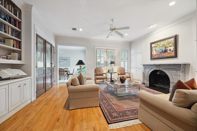 3633 Overbrook Ln, Houston, TX 77027 - living room with a ceiling fan, light wood finished floors, a fireplace with flush hearth, crown molding, and recessed lighting