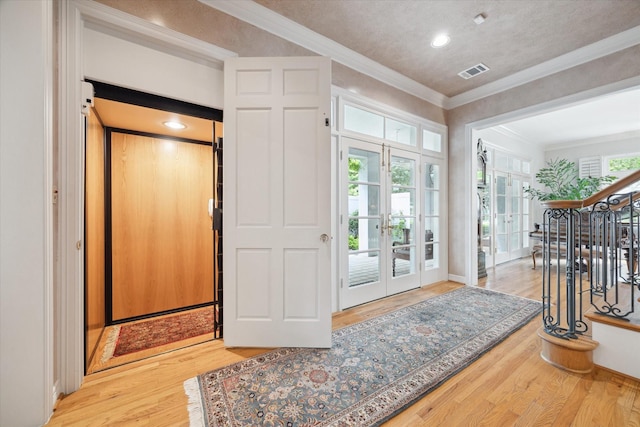 3633 Overbrook Ln, Houston, TX 77027 - foyer featuring wood finished floors, french doors, crown molding, recessed lighting, and elevator