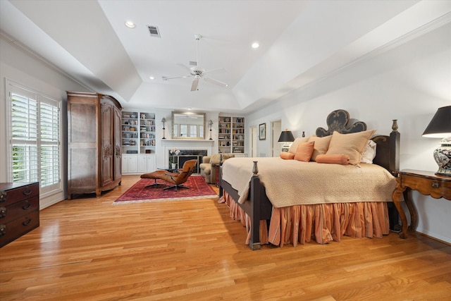 3633 Overbrook Ln, Houston, TX 77027 - bedroom featuring light wood-type flooring, lofted ceiling, recessed lighting, a fireplace, and ceiling fan
