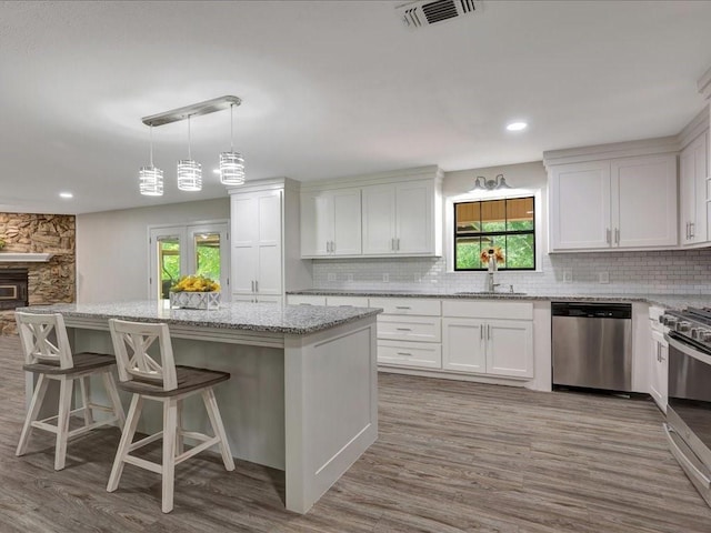 4449 Benton Rd, Lufkin, TX 75901 - kitchen featuring appliances with stainless steel finishes, a sink, light wood-type flooring, healthy amount of natural light, and recessed lighting
