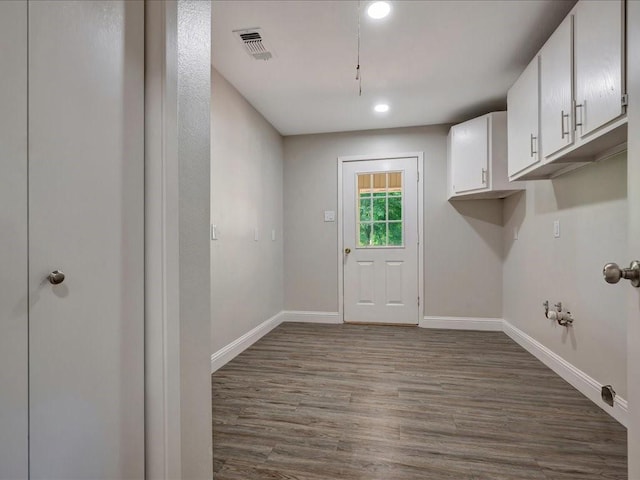4449 Benton Rd, Lufkin, TX 75901 - washroom featuring gas dryer hookup, dark wood finished floors, baseboards, cabinet space, and recessed lighting