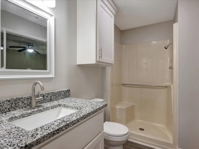 4449 Benton Rd, Lufkin, TX 75901 - bathroom featuring toilet, a shower, vanity, and wood finished floors