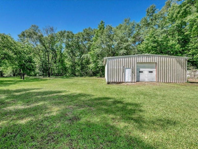 4449 Benton Rd, Lufkin, TX 75901 - view of grassy yard featuring a detached garage and an outdoor structure