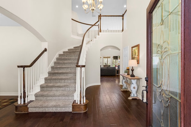 3610 Wellspring Lake Dr, Fulshear, TX 77441 - entrance foyer featuring arched walkways, wood-type flooring, stairway, baseboards, and a high ceiling