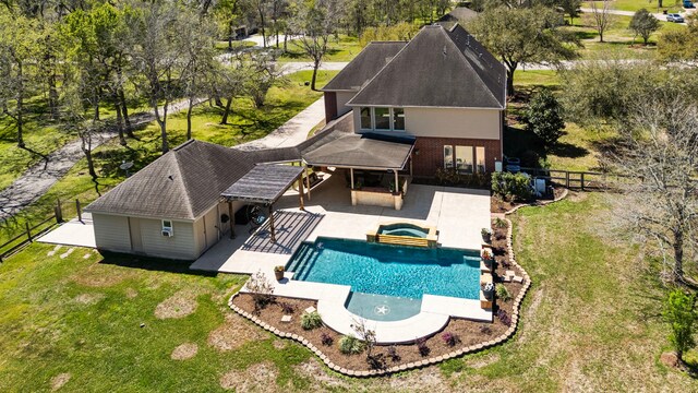 3610 Wellspring Lake Dr, Fulshear, TX 77441 - rear view of house with a patio area, brick siding, a pool with connected hot tub, and roof with shingles