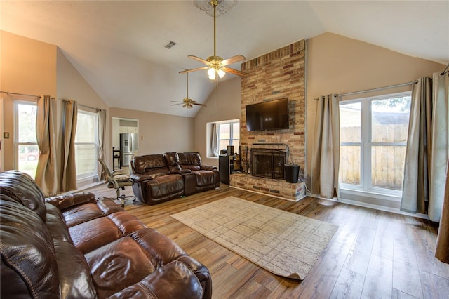 14927 Cypress Green Dr, Cypress, TX 77429 - living area with lofted ceiling, ceiling fan, a brick fireplace, and wood finished floors