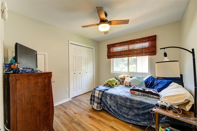 14927 Cypress Green Dr, Cypress, TX 77429 - bedroom with light wood-type flooring, a closet, ceiling fan, and baseboards