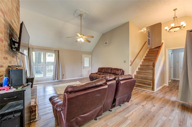 14927 Cypress Green Dr, Cypress, TX 77429 - living room with light wood finished floors, a chandelier, stairway, a ceiling fan, and high vaulted ceiling