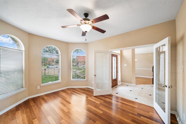 26 Oakmont Ct, Jersey Village, TX 77064 - unfurnished room featuring french doors, ceiling fan, and light wood-style flooring