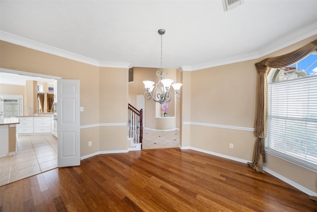 26 Oakmont Ct, Jersey Village, TX 77064 - empty room with a chandelier, baseboards, crown molding, light wood-type flooring, and stairs