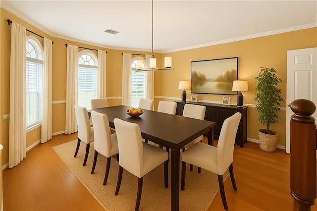 26 Oakmont Ct, Jersey Village, TX 77064 - dining space featuring light wood-style flooring, ornamental molding, and baseboards