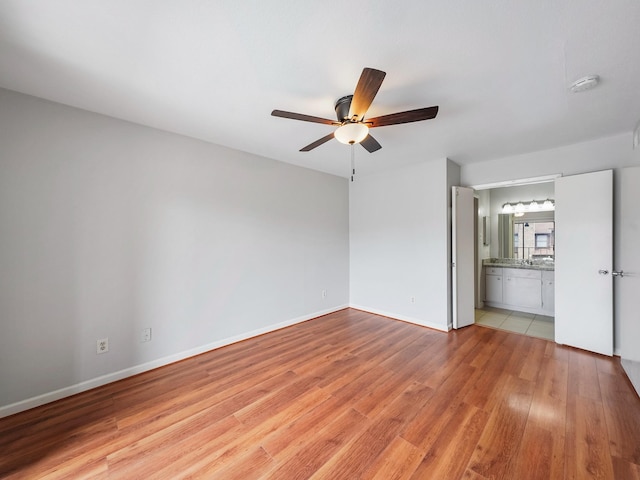 6633 W Airport Blvd Unit 1106, Houston, TX 77035 - unfurnished room with a smoke detector, ceiling fan, light wood finished floors, and baseboards