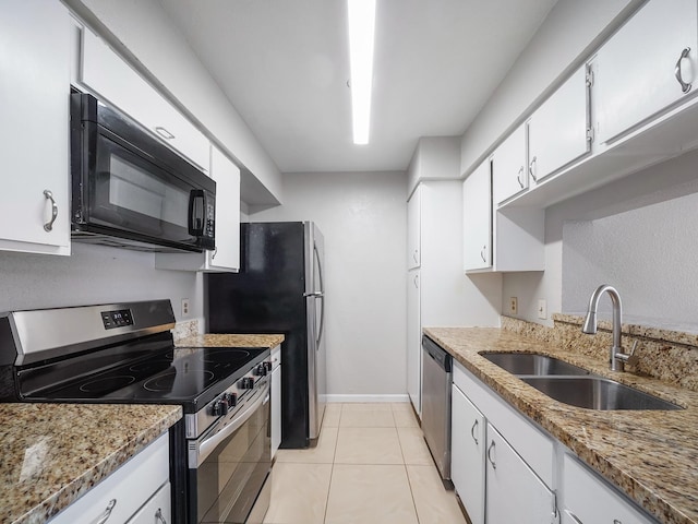 6633 W Airport Blvd Unit 1106, Houston, TX 77035 - kitchen with appliances with stainless steel finishes, a sink, white cabinetry, light stone counters, and light tile patterned floors