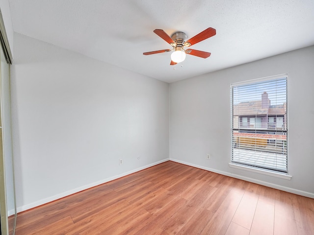6633 W Airport Blvd Unit 1106, Houston, TX 77035 - unfurnished room featuring light wood finished floors, baseboards, and a ceiling fan