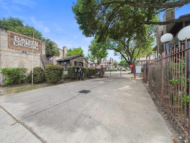 6633 W Airport Blvd Unit 1106, Houston, TX 77035 - view of concrete road with a gate and a residential view