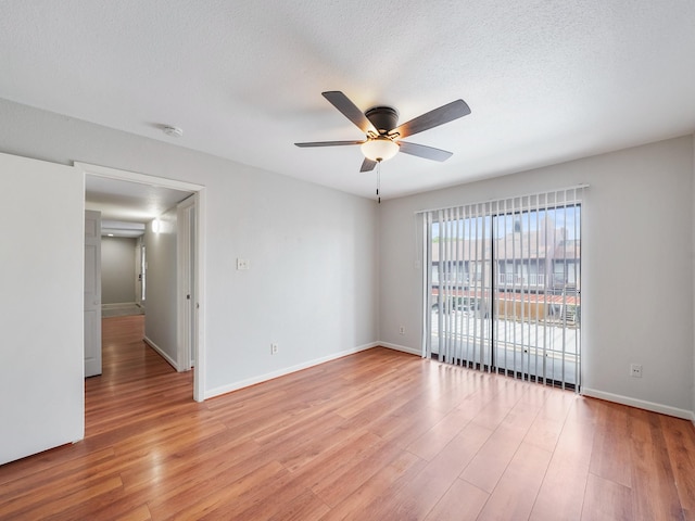 6633 W Airport Blvd Unit 1106, Houston, TX 77035 - empty room featuring a ceiling fan, light wood-style floors, baseboards, and a textured ceiling