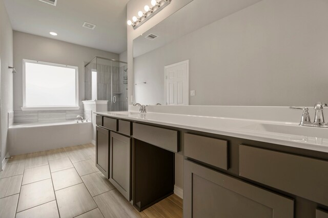 269 Bay Oaks Dr, La Porte, TX 77571 - bathroom featuring a stall shower, a garden tub, double vanity, and tile patterned flooring