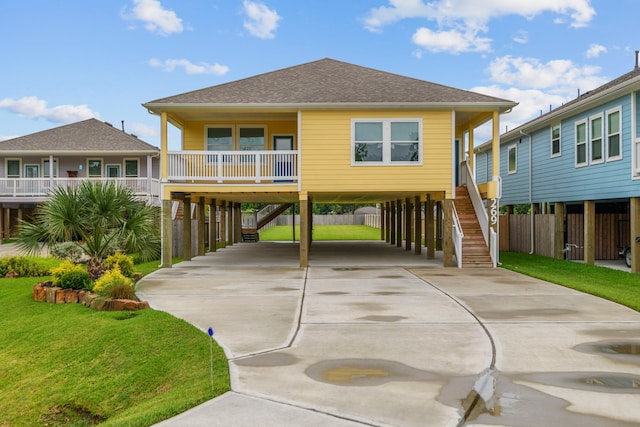 269 Bay Oaks Dr, La Porte, TX 77571 - rear view of house with stairs, a carport, concrete driveway, and a shingled roof