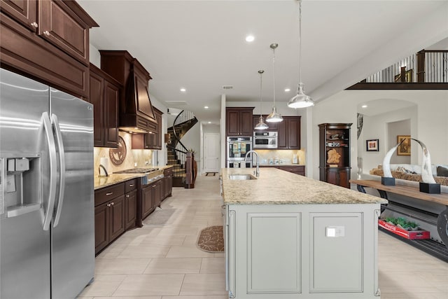 2410 Legends Way, Katy, TX 77493 - kitchen featuring stainless steel appliances, a sink, recessed lighting, backsplash, and a kitchen island with sink